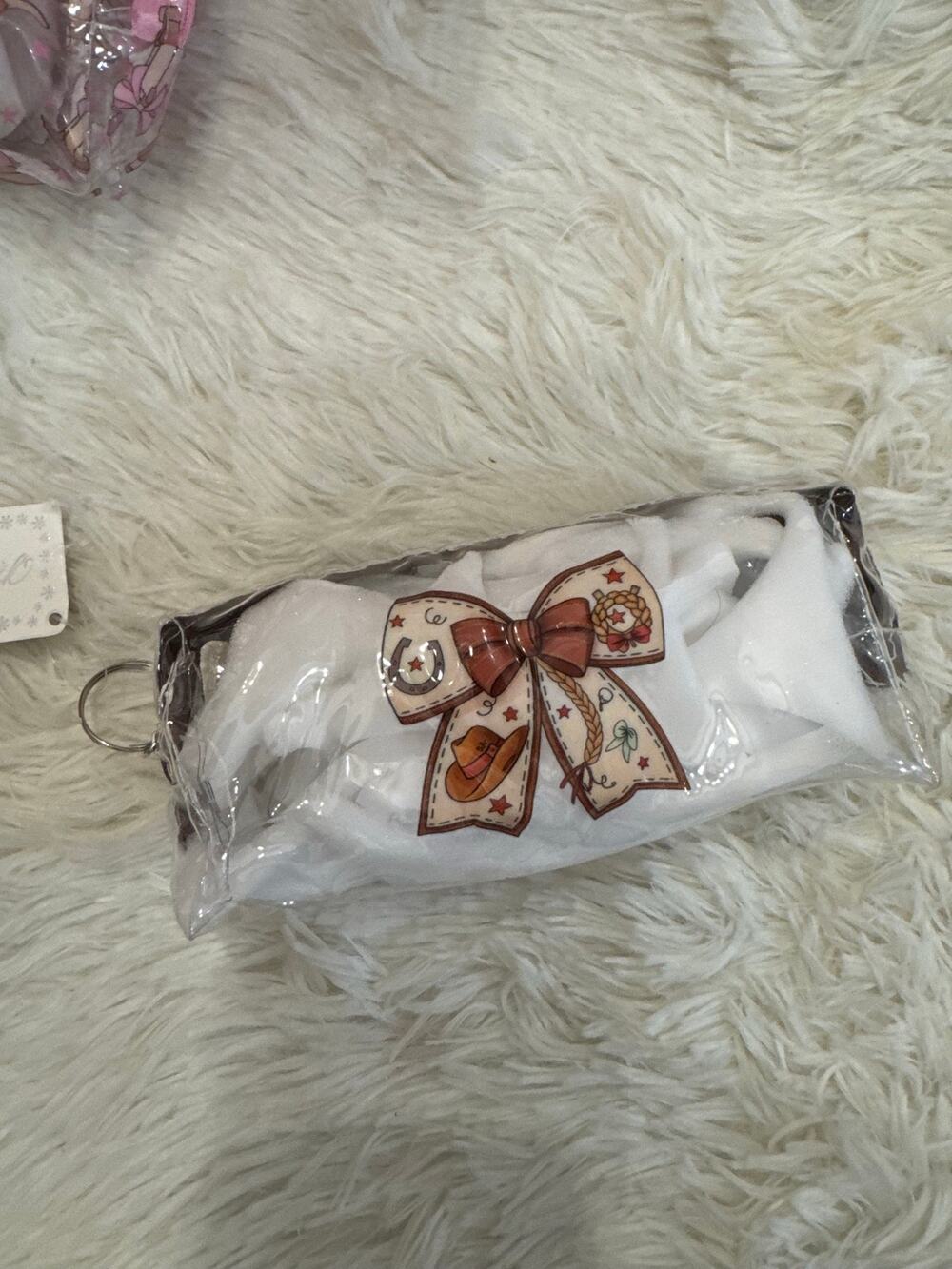 Brown & white cowboy-themed pouch brown bow graphic stars and a cowboy hat